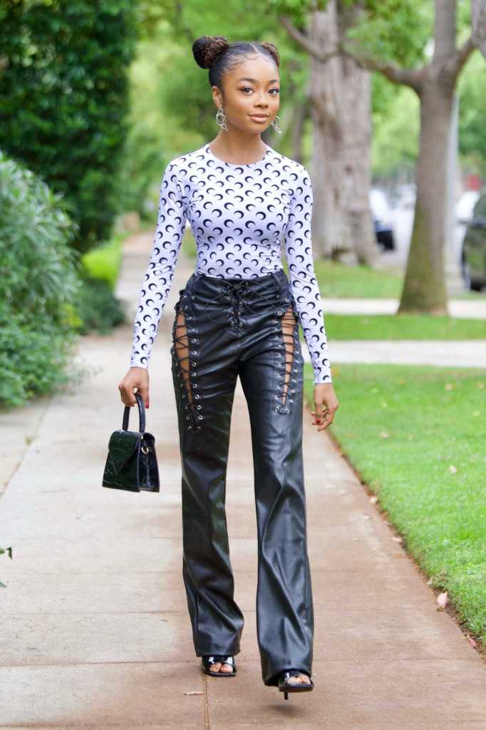 What to Wear With Black Pants - Skai Jackson Leather Pants Black Clutch